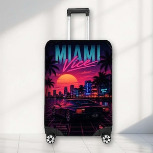 May include: A rolling suitcase featuring a vibrant graphic print of a sunset over a city skyline with palm trees, a sports car, and the text MIAMI Vice. The luggage has a black frame, a retractable handle, and four wheels at the base.