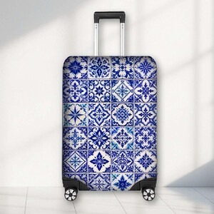 May include: A rectangular upright suitcase featuring a repeating pattern of blue and white decorative tiles. The luggage has a retractable black handle at the top and four black spinner wheels at the base, providing a stable and mobile design.