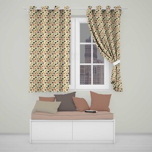 May include: A pair of eyelet curtains featuring a repeating pattern of small, colourful vintage cameras on a light cream background. The curtains are hung on a white rod, with one panel pulled to the side, revealing a window view of a city building.