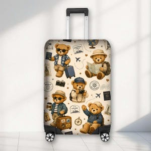 May include: A rolling suitcase featuring a cream-coloured background with a repeating pattern of teddy bears dressed for travel. The bears are depicted with accessories like sunglasses, hats, cameras, and suitcases, alongside travel-themed icons.