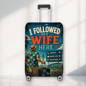 May include: A rolling suitcase with a retractable handle featuring a graphic of a person in a floral shirt and hat standing before an airport sign that reads I FOLLOWED MY WIFE HERE, ARRIVALS, BAGGAGE CLAIM, and GOOD DECISIONS with a small airplane icon.