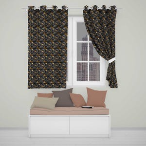 May include: Two window curtains featuring a dark black background with a repeating pattern of small gold and white geometric shapes. The curtains are hung on a silver rod, with one panel pulled to the side, revealing a window with a city view.