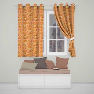 May include: Two orange curtains featuring a repeating pattern of cartoon foxes and autumn leaves. The curtains are hung on a white rod over a window. Below the window is a white bench with a light pink cushion and four solid-coloured pillows.