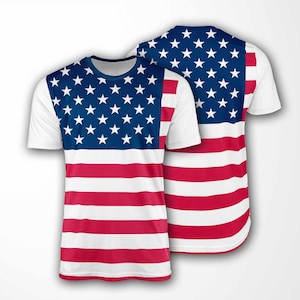 May include: White short-sleeved t-shirt featuring the American flag design. The top portion of the shirt has a blue background with white stars, and the lower portion has red and white stripes. The shirt is displayed from the front and back.