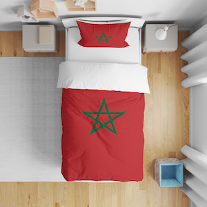 May include: Red bedding set with a green five-pointed star design. The duvet cover and pillowcase feature the star. The bed is made with white sheets and a red duvet cover. The set is on a wooden floor.