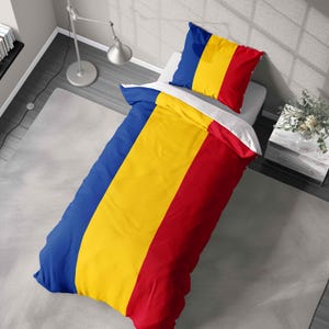 May include: A duvet cover and pillowcase set with a design inspired by the Romanian flag. The bedding set features vertical stripes of blue, yellow, and red. The pillowcase is rectangular and the duvet cover is rectangular.