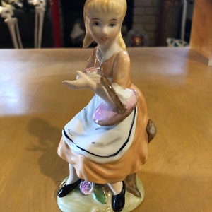 Vintage girl with flower basket figurine