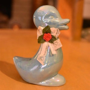 Blaue Ente mit Bogenfigur