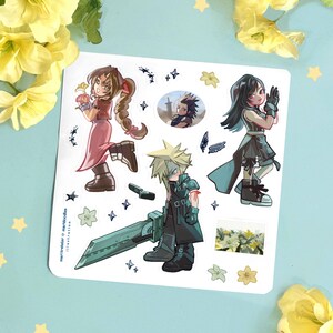 May include: A sticker sheet featuring Final Fantasy characters. The sheet includes illustrations of Cloud, Tifa, Aerith, and other characters. The artwork is in a cartoon style with vibrant colors and detailed designs. The background is a light blue with yellow floral accents.