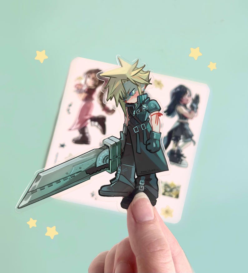 May include: A clear sticker featuring a cartoon illustration of Cloud Strife from Final Fantasy VII, holding a large sword. The sticker has a light blue background with yellow star accents and images of other characters.