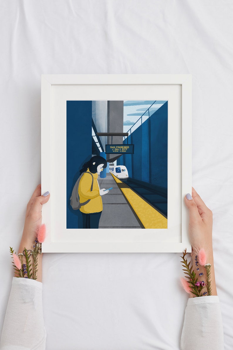 May include: A digital illustration of a person waiting at a train station platform. The person is wearing a yellow jacket and a backpack. The train station sign reads "San Francisco Airport".