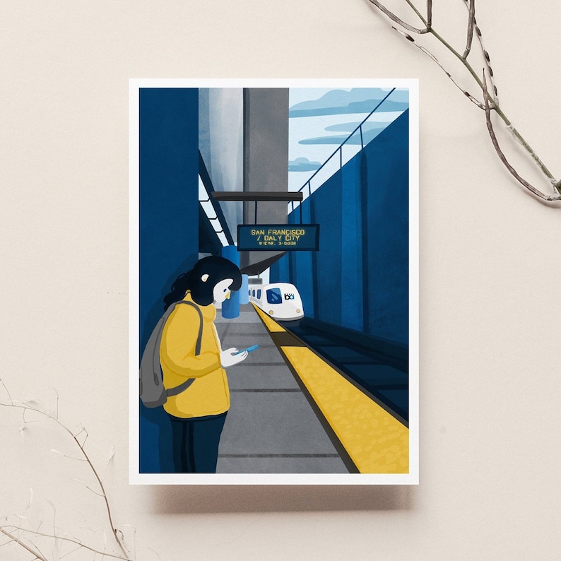 May include: A woman in a yellow jacket stands on a platform at a train station. A white train with the words "San Francisco / Daly City" on a sign is pulling into the station.