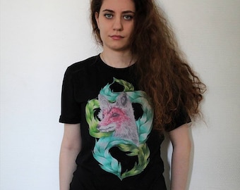 May include: A black t-shirt with a graphic print of a fox's head surrounded by green leaves.