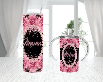May include: Two stainless steel tumblers with pink floral designs and glitter accents. The larger tumbler says "Mama" and the smaller tumbler says "Mini".