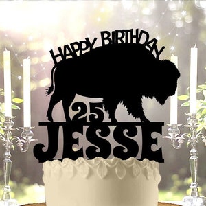 May include: Black silhouette cake topper featuring a buffalo with the text "Happy Birthday" above and "25 Jesse" below.