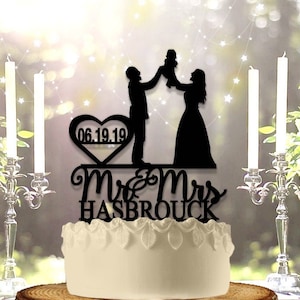 Couple Holding up Baby Personalized Wedding Cake Topper