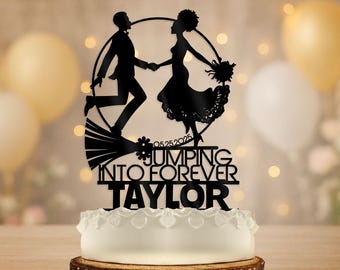 May include: Black silhouette cake topper featuring a running couple holding hands, with the words "Jumping Into Forever Taylor" and the date 05.25.2025. The topper is placed on a white cake with decorative frosting.