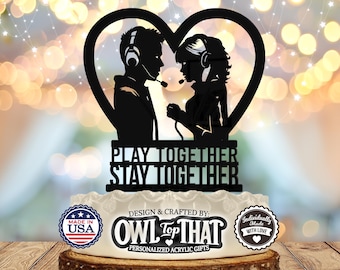 May include: Black silhouette of a couple wearing headphones, inside a heart shape, with the text "PLAY TOGETHER STAY TOGETHER". Below the couple is the text "DESIGN & CRAFTED BY: OWL THAT PERSONALIZED ACRYLIC GIFTS". There are two circular logos, one with the text "MADE IN USA" and the other with the text "Individually Made WITH LOVE".