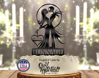 May include: Black metal cake topper featuring a silhouette of Jack Skellington and Sally from The Nightmare Before Christmas. The topper includes a heart with the date 07.23.25 and the text "BUNNAGE". The topper is made by Owl Top That! Personalized Cake Toppers.