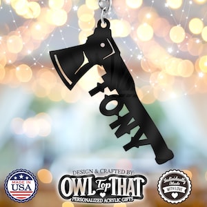 May include: Black acrylic keychain with a silhouette of an axe and the word "FONY" written in a stylized font. The keychain is designed and crafted by "OWL Top THAT" and is a personalized acrylic gift.