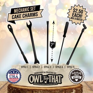 May include: Black mechanic-themed cake charms in five styles, including wrenches and screwdrivers. The charms are approximately 7 inches long and are displayed on a cake. The text "MECHANIC SET CAKE CHARMS" is at the top.