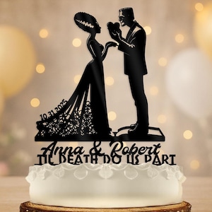 May include: A black laser-cut cake topper depicting a bride and groom in the style of Frankenstein's monster. The date "10.31.2025" is included, along with the names "Anna & Robert" and the phrase "Til Death Do Us Part".