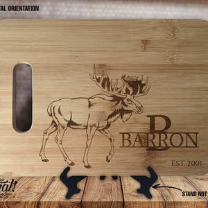 May include: A personalised bamboo chopping board with a laser engraved image of a moose and the text "Barron Est. 2001".