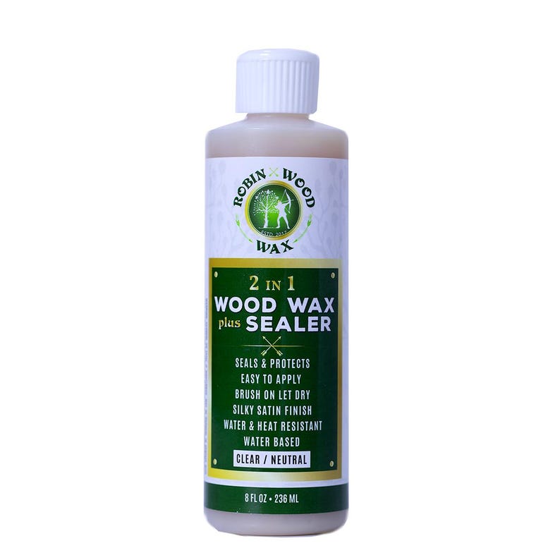 Puede incluir: Botella de cera para madera y sellador Robin Wood 2 en 1. La etiqueta muestra detalles del producto, incluyendo "Sella y protege" y "Transparente/Neutro". Contiene 236 ml.