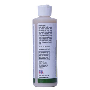 Puede incluir: Una botella de cera para madera con tapa blanca y l&iacute;quido beige. La etiqueta incluye instrucciones de uso, indicando que se seca en 2 horas y cubre aproximadamente 3,7 metros cuadrados. Fabricado en EE. UU.