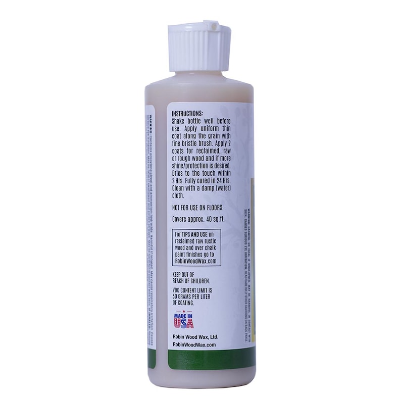 Puede incluir: Una botella de cera para madera con tapa blanca y l&iacute;quido beige. La etiqueta incluye instrucciones de uso, indicando que se seca en 2 horas y cubre aproximadamente 3,7 metros cuadrados. Fabricado en EE. UU.