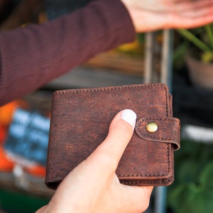 Rich-brown, vegan wallet held in hand.