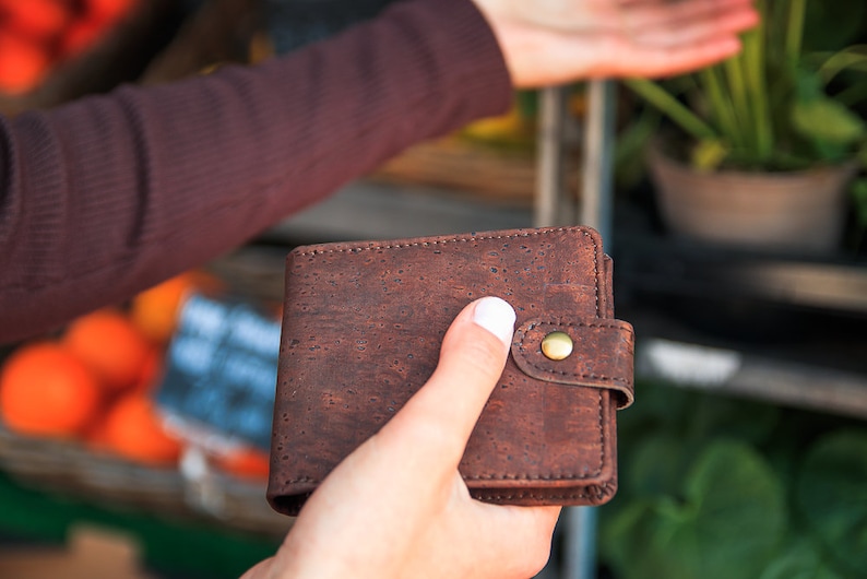 Rich-brown, vegan wallet held in hand.