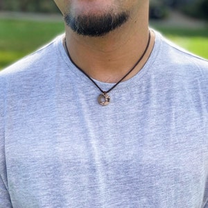 Customised wave necklace with waxed cotton cord, pictured on male model.