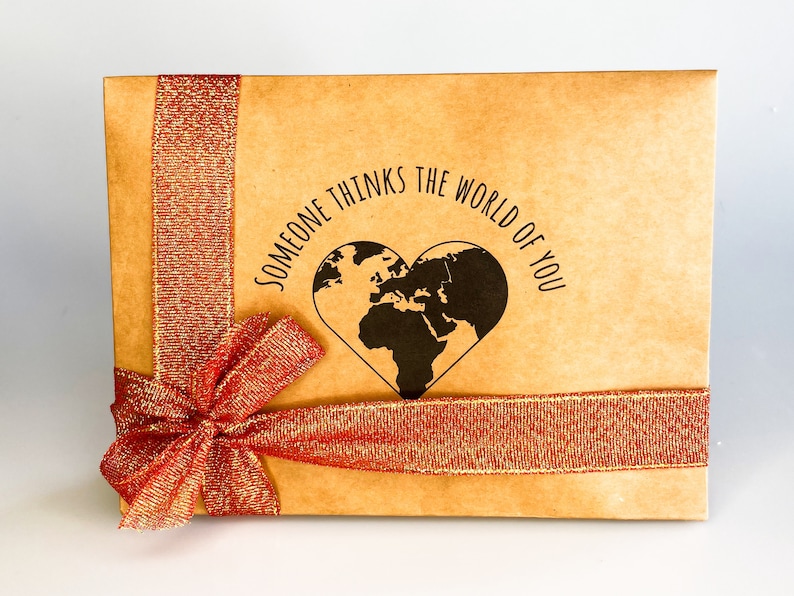 Gift box featuring a red bow with message "someone thinks the world of you" written in the middle. Perfect for showing appreciation and appreciation for a loved one