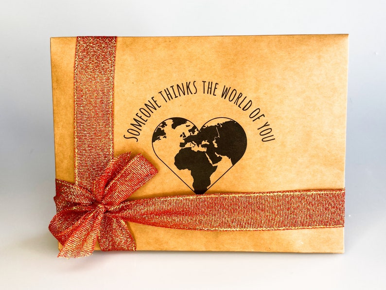 Gift box featuring a red bow with message "someone thinks the world of you" written in the middle. Perfect for showing appreciation and appreciation for a loved one.
