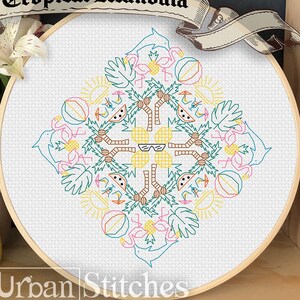 May include: A colorful cross-stitch embroidery hoop with a tropical mandala design. The design features pineapples, palm trees, watermelon, sunglasses, and flamingos. The hoop is labeled "Tropical Mandala" and "Urban Stitches".
