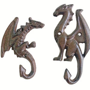 May include: Two cast iron dragon hooks in a rustic brown finish. The hooks are detailed with wings, scales, and a curved tail, perfect for a fantasy-themed decor. Each hook has mounting holes for easy installation.