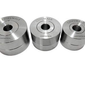 May include: Three silver metal die sets with different sizes, 1.25 female, 1.5 female, and 1.75 female. Each die set has a circular hole in the centre and the text "UTV DISTRIBUTION INC" is printed on the bottom of each die set.