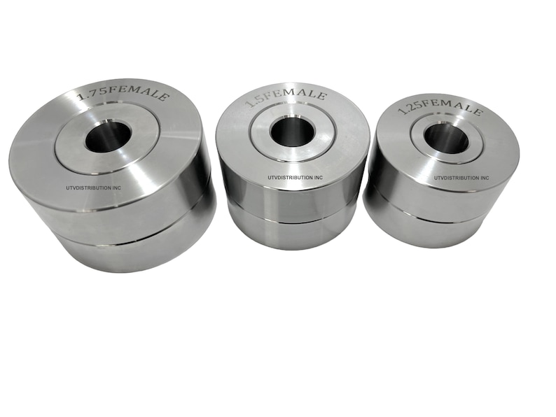 May include: Three silver metal die sets with different sizes, 1.25 female, 1.5 female, and 1.75 female. Each die set has a circular hole in the centre and the text "UTV DISTRIBUTION INC" is printed on the bottom of each die set.