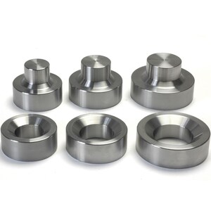 May include: Set of six silver metal rings of varying sizes. The rings are smooth and have a slightly raised lip around the edge.