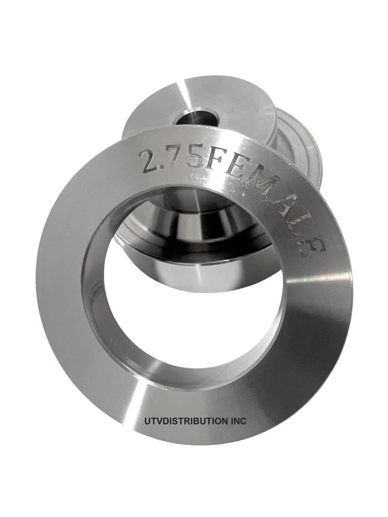 May include: A silver metal ring with the text "2.75FEMALES" and "UTVDISTRIBUTION INC" engraved on it.