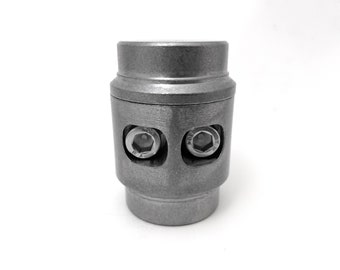 May include: A silver metal pipe clamp with two visible screws. The clamp is designed to secure pipes together.