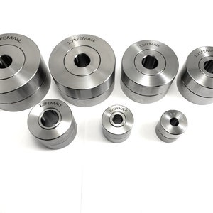 May include: A set of seven silver metal female die sets in various sizes, including 0.5, 0.75, 1.0, 1.25, 1.5, 1.75, and 2.0 inches.