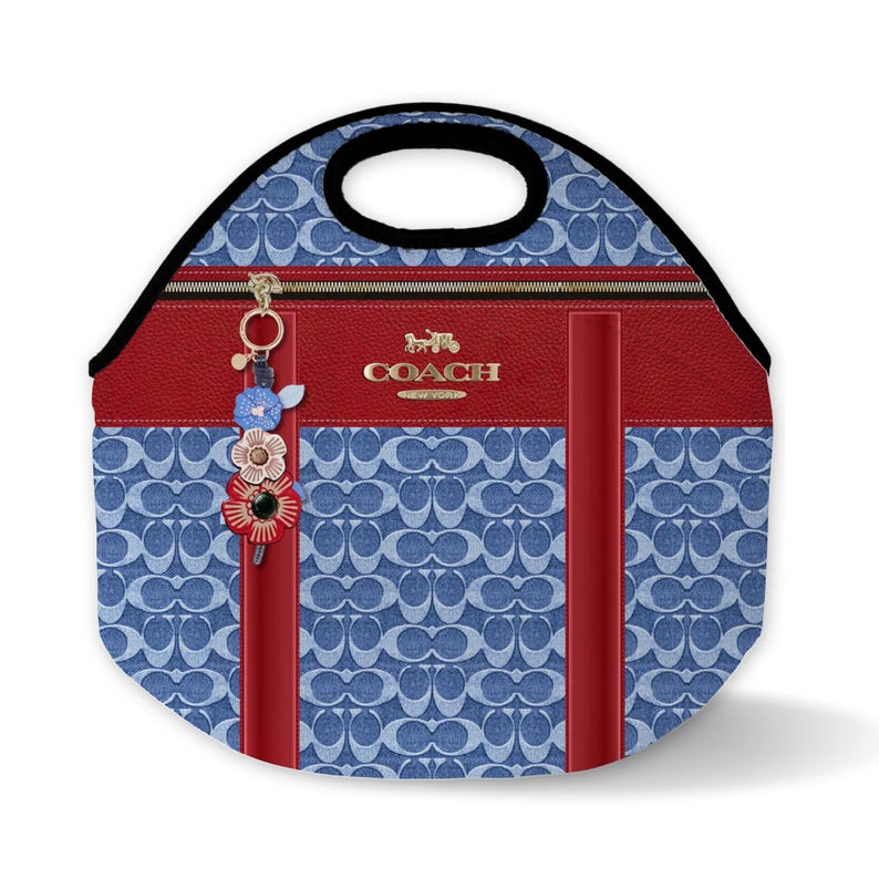 May include: A blue and red insulated lunch bag with a Coach logo and a floral charm. The bag has a black handle and a zipper closure.