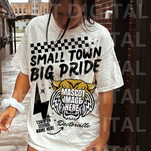 May include: White t-shirt with black text that reads "Small Town Big Pride" and a black and gold mascot graphic with the text "Mascot Image Here". The text "Town or School Name Here" is written below the mascot graphic with an arrow pointing to the text "Dectorville".