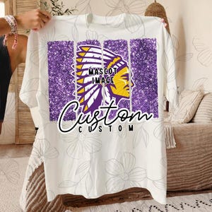 May include: White t-shirt with a purple glitter design featuring a Native American headdress and the text "MASCOT IMAGE" and "Custom CUSTOM".