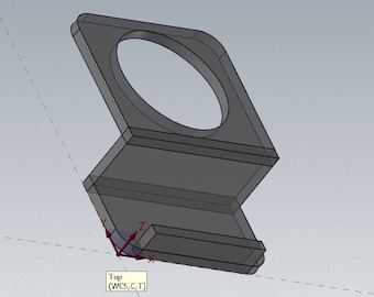 Op de afbeelding: Een 3D-model van een grijze telefoonstandaard van plastic met een ronde uitsparing voor een telefoon. De standaard heeft een klein plankje voor oplaadkabels.