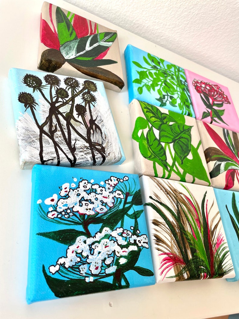 May include: Nine small square canvases with painted floral and foliage designs. The canvases are arranged in a grid pattern and feature a variety of colors, including green, pink, red, white, and blue.