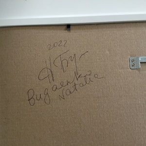 May include: A brown cardboard backing with a white frame. The backing has handwritten text that says "2022", "A.Try", "Bug aenko", and "Natalie".