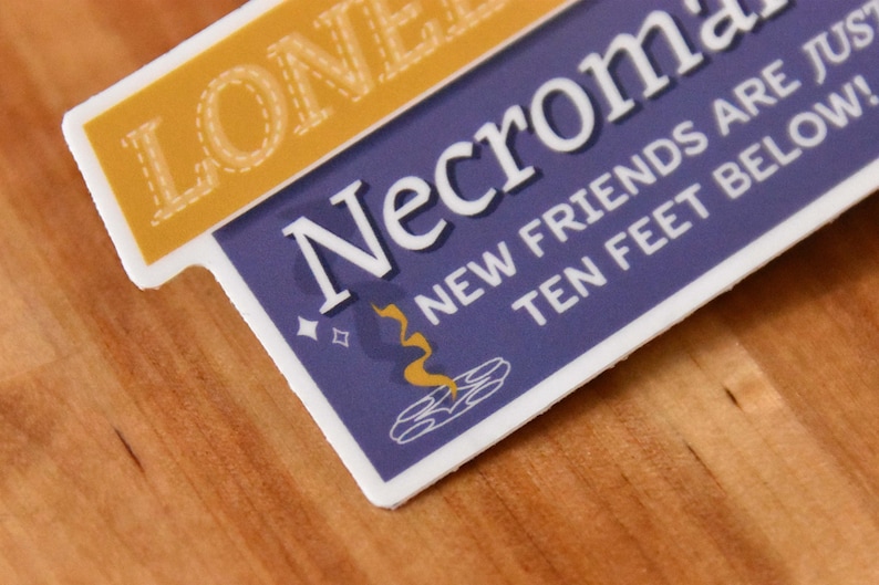 A die cut vinyl sticker in a typographic design. It reads "Lonely? Try Necromancy. New friends are just ten feet below!" A friendly looking skull says "Hi" alongside a summoning circle with swirling magic. The finish is matte and waterproof.